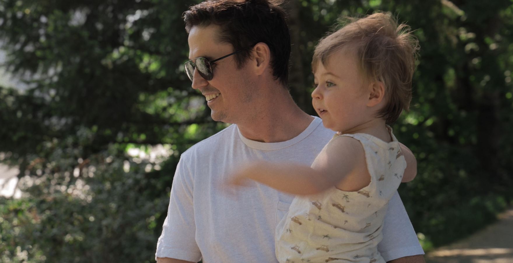 Dad and toddler enjoying a walk in the trees